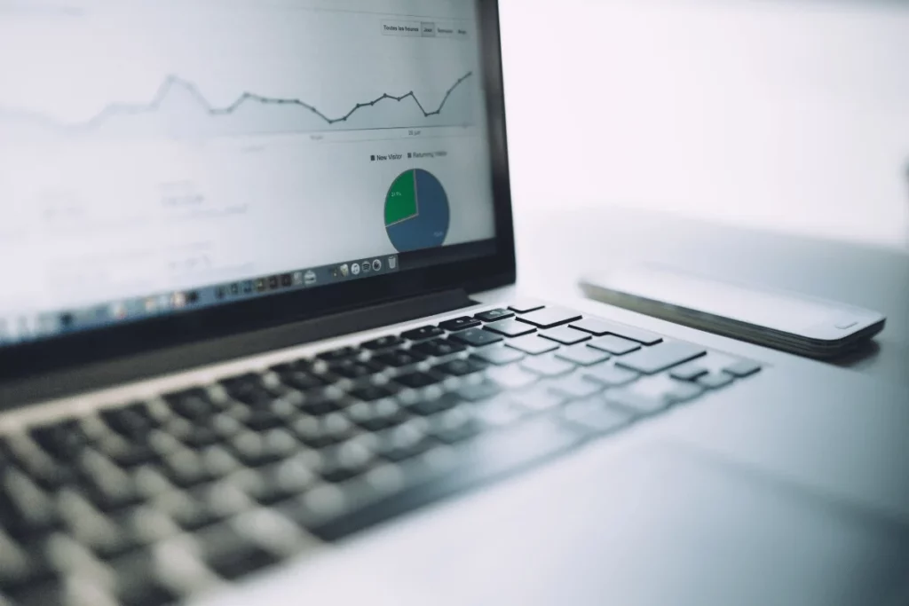 Laptop screen displaying a graph and pie chart with website traffic data analysis.
