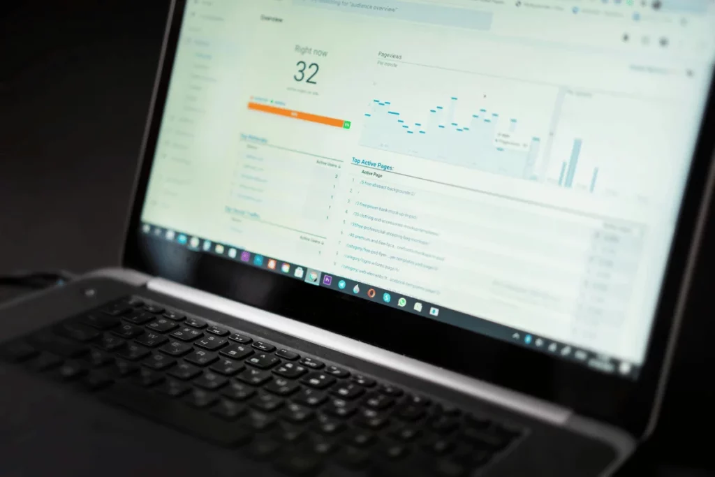 Laptop showing live pageviews and user data in Google Analytics dashboard.