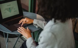 Person analyzing data charts on laptop for effective B2B blog strategy and content conversion optimization.