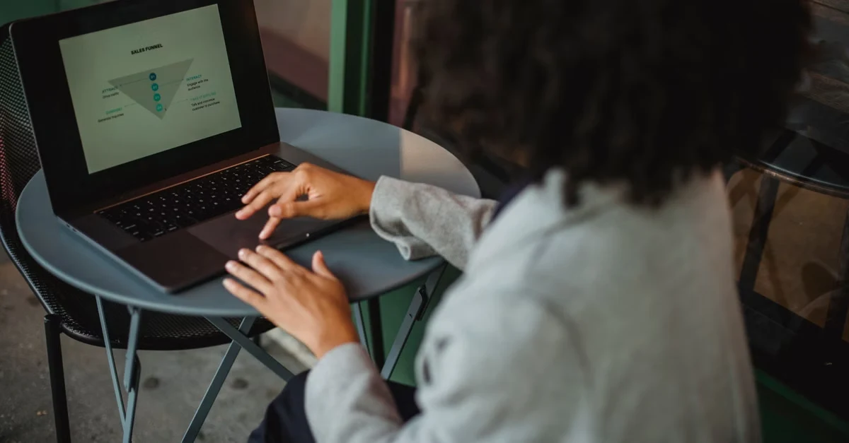 Person analyzing data charts on laptop for effective B2B blog strategy and content conversion optimization.